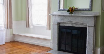 fireplace inside bedroom at drayton house, next to window