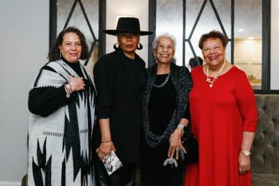 Group of four women smiling for photo